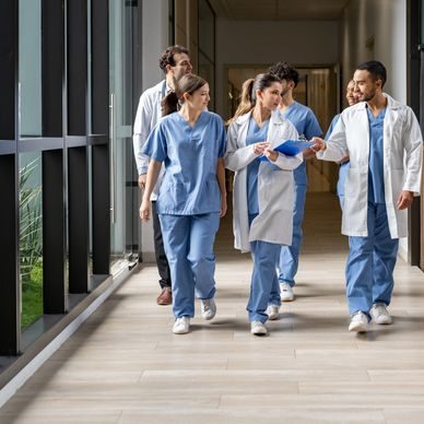 Doctors and medical students walking through a hospital corridor