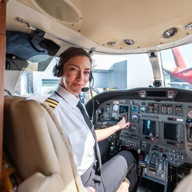 Commercial pilot in uniform at the controls of an aircraft